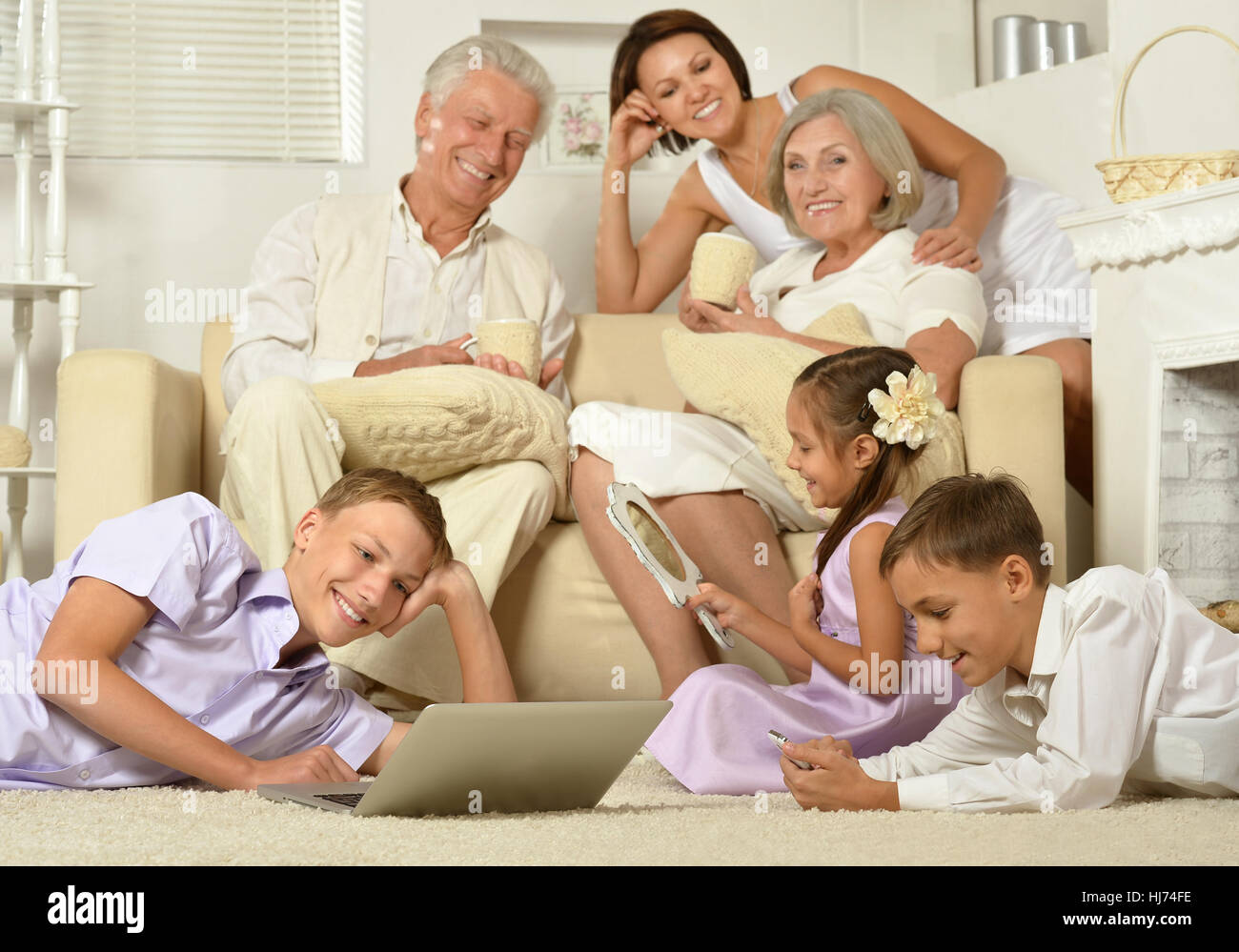 big family posing in home interior Stock Photo - Alamy
