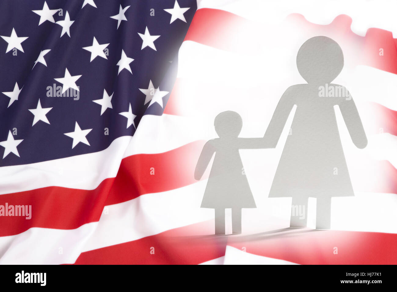 Single mother with daughter in United States, paper figures Stock Photo