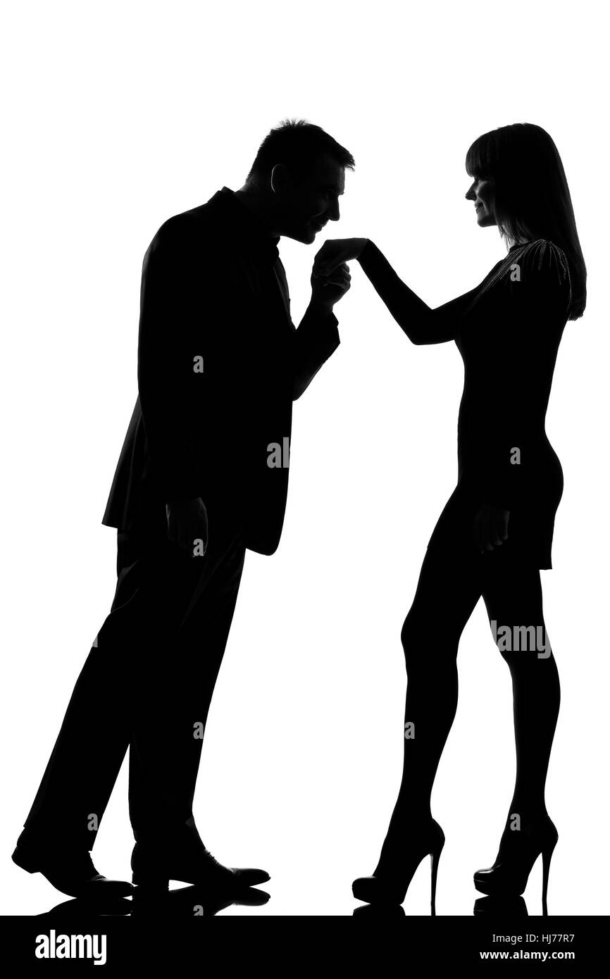 one caucasian man kissing hand woman  in studio silhouette isolated on white background Stock Photo