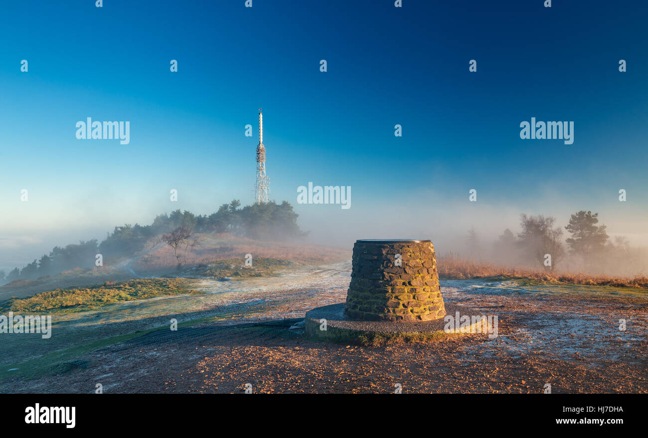 Transmitting Station at the Top of Hill in Morning Mist and Sunrise Light Stock Photo