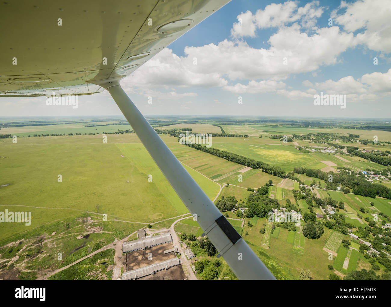 View from the pilot's seat of a small light plane while flying over the rural area Stock Photo