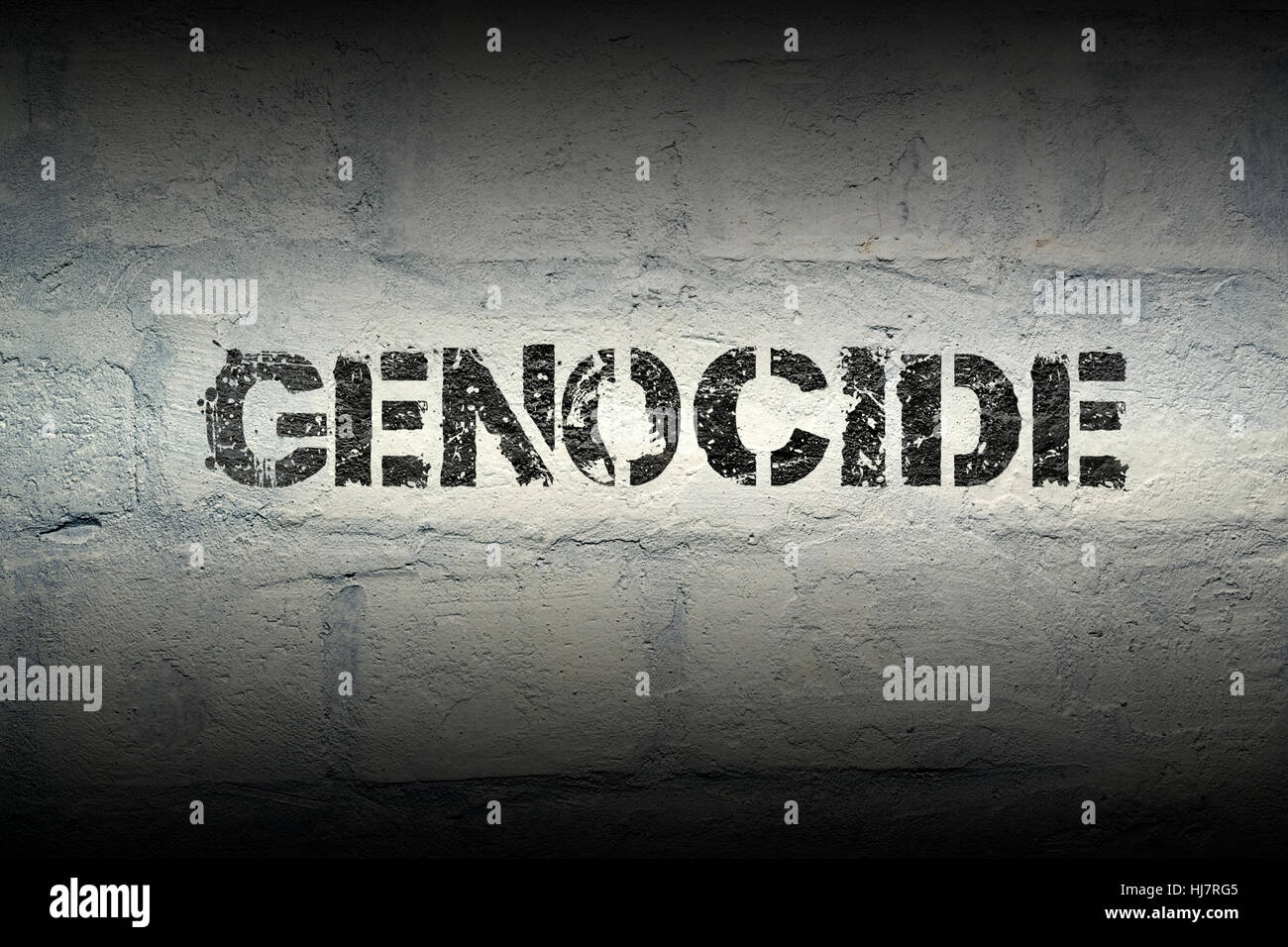 genocide stencil print on the grunge white brick wall Stock Photo