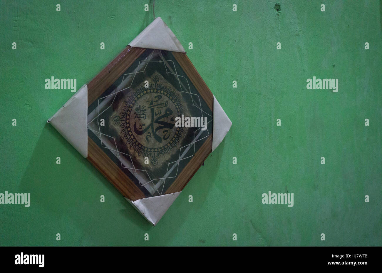 the art of calligraphy in a wood framed on green wall photo taken in Jakarta Indonesia Stock