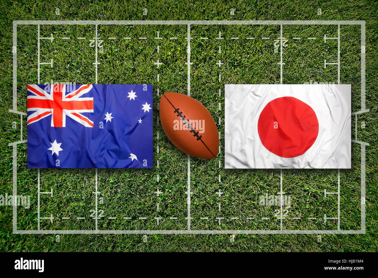 Australia vs. Japan flags on green rugby field Stock Photo