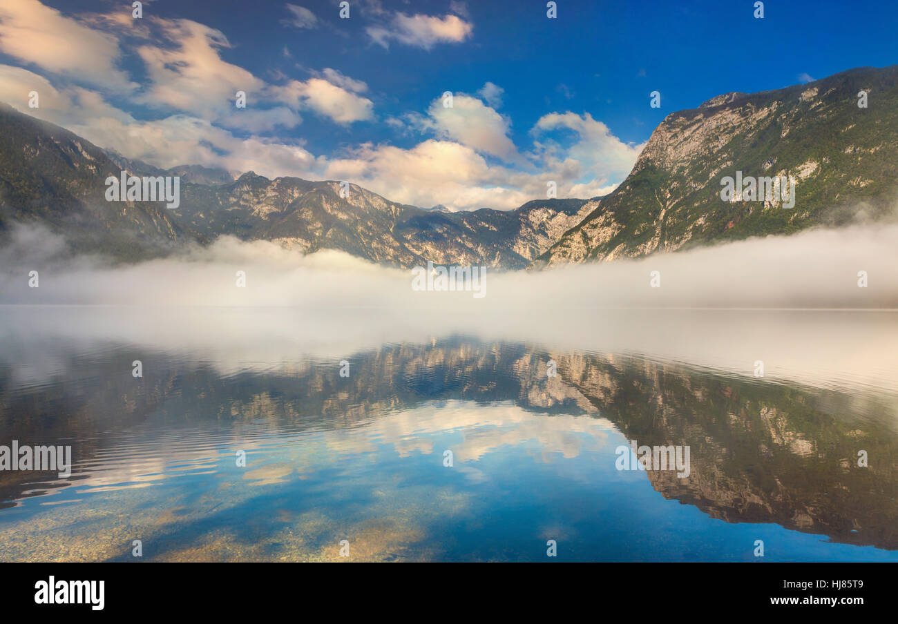 Foggy summer morning on the Bohinj lake in Triglav national park Slovenia, Alps, Europe. Stock Photo