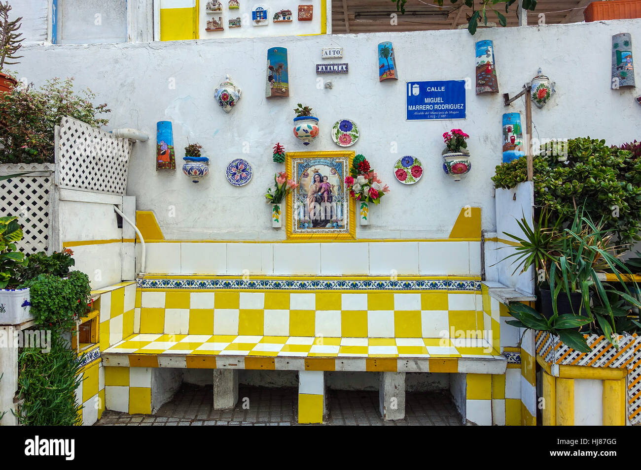 Quiet corner of Arguineguin, with tiled wall, plaques and plates and bench, Gran Canaria, Spain Stock Photo