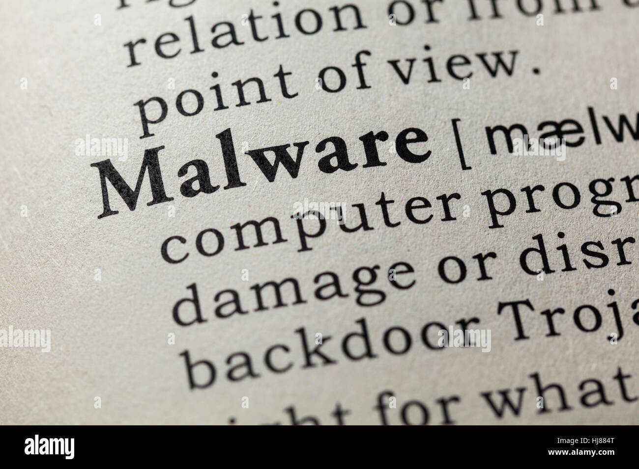 Fake Dictionary, Dictionary definition of the word Malware. including key descriptive words. Stock Photo