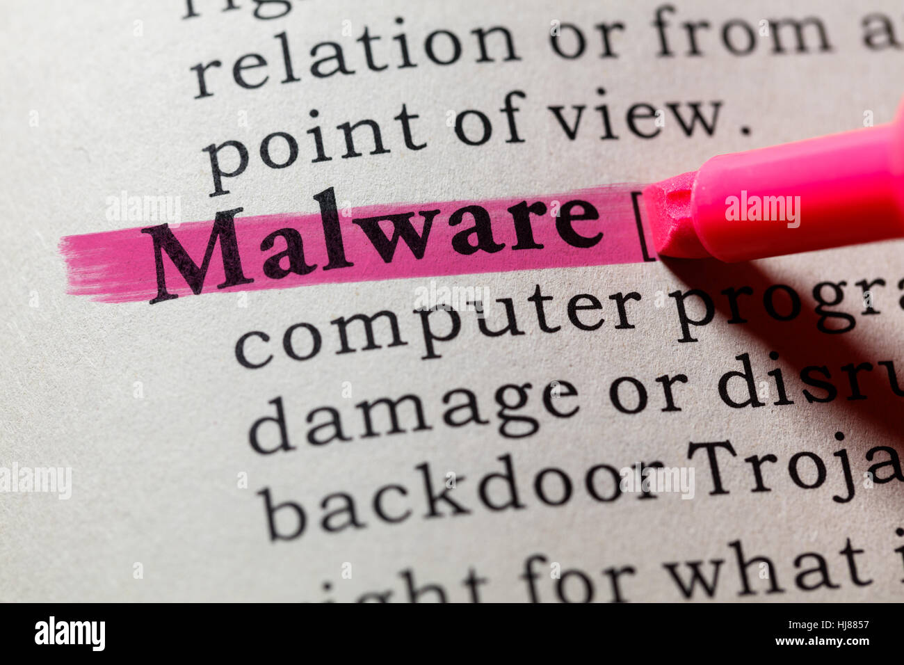 Fake Dictionary, Dictionary definition of the word Malware. including key descriptive words. Stock Photo