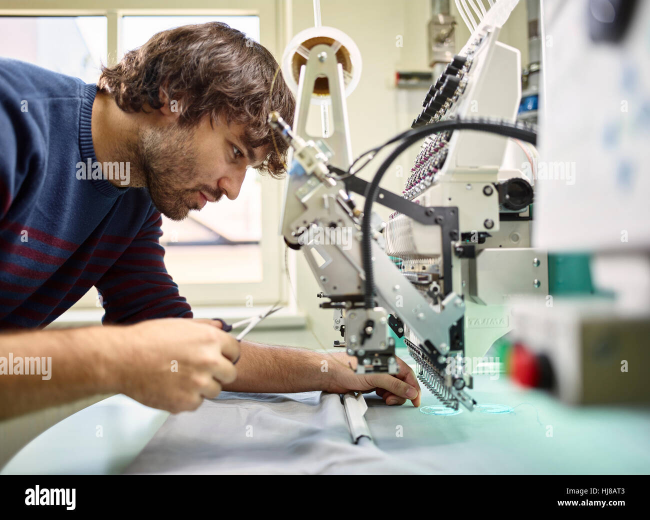 Man working, embroidery machine, Austria Stock Photo