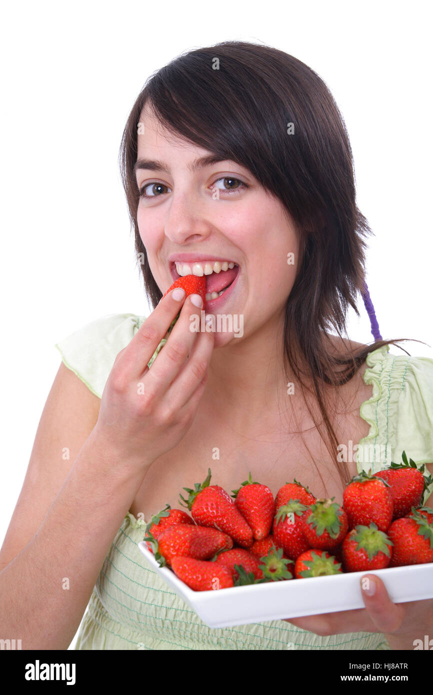 Young woman eats strawberry Stock Photo