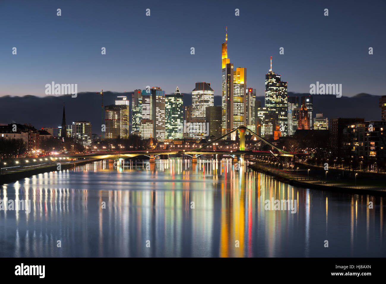 Skyline at dusk, brightly lit, blue hour, reflection, Deutschherrnbrücke, Frankfurt, Hesse, Germany Stock Photo