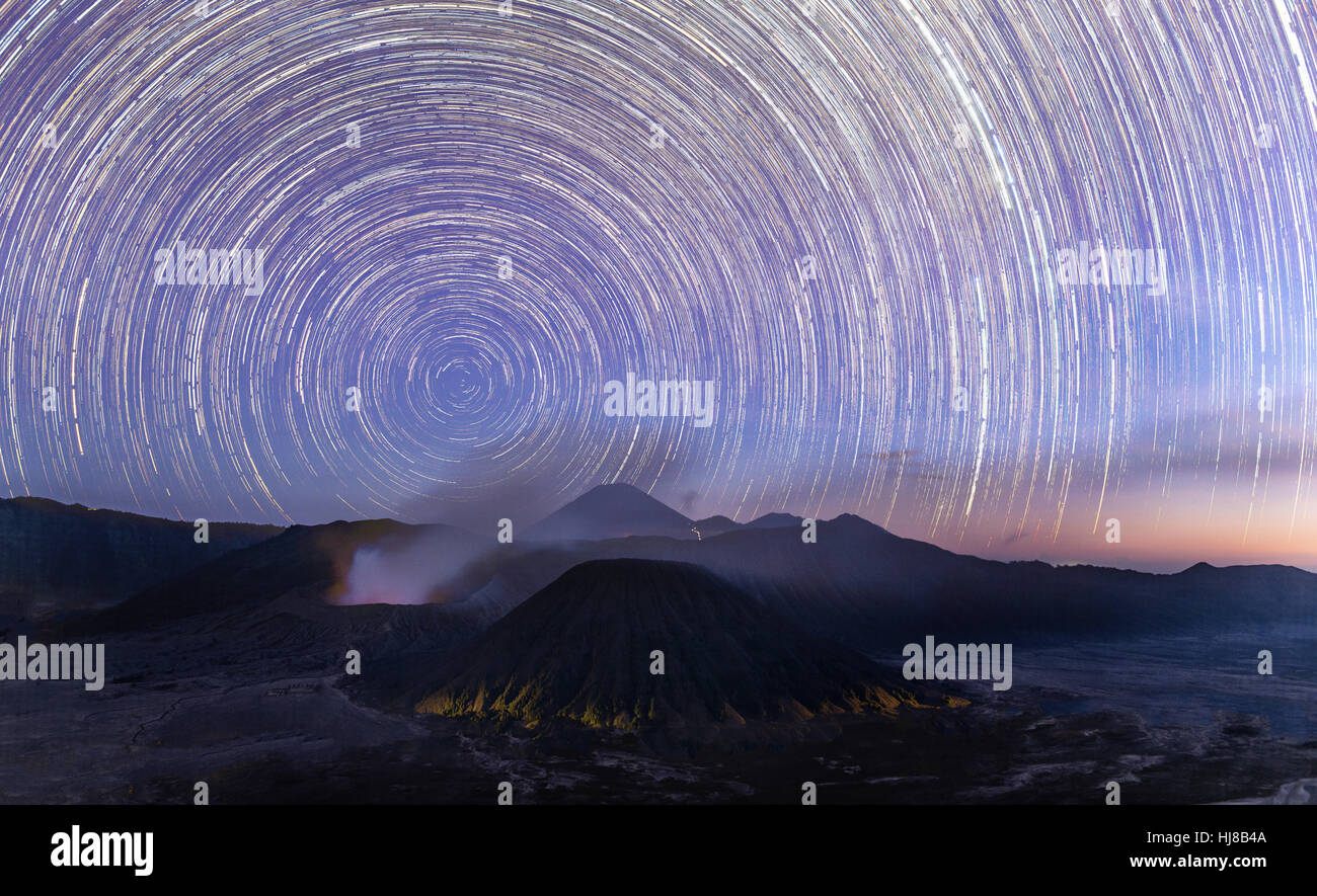 Night shot with stars, time exposure, Startrails volcanic landscape, smoking active volcano Gunung Bromo, front Mount Batok, Stock Photo