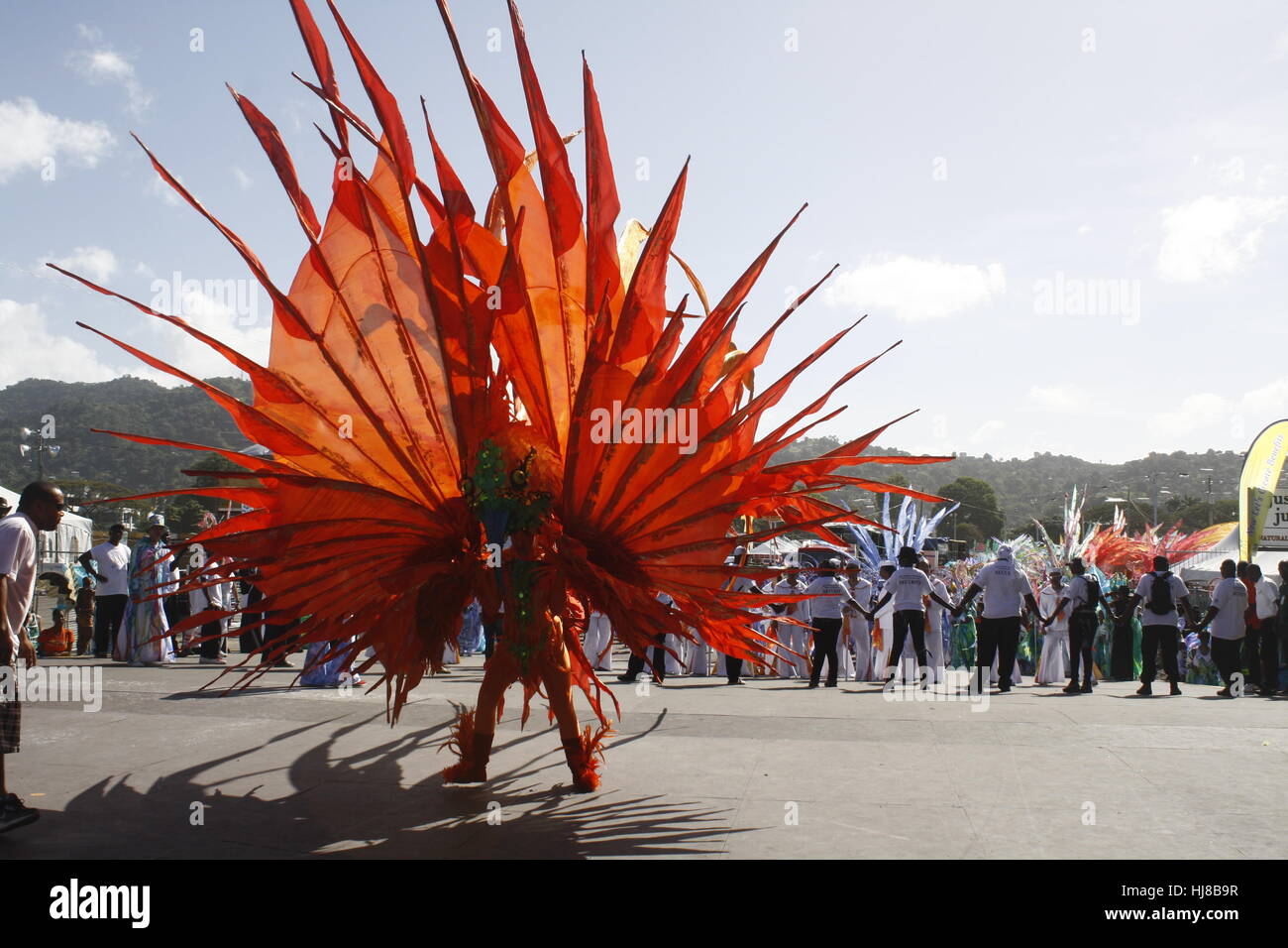 Person dancing Carnival in Orange Costume  In Trinidad. Stock Photo