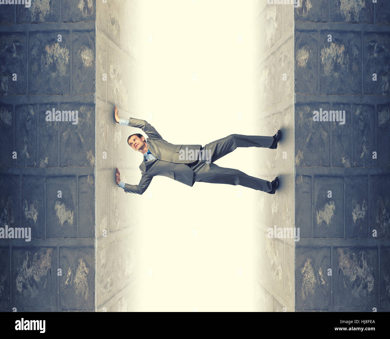 Stuck In Between Young troubled businessman trapped between two walls Stock Photo - Alamy
