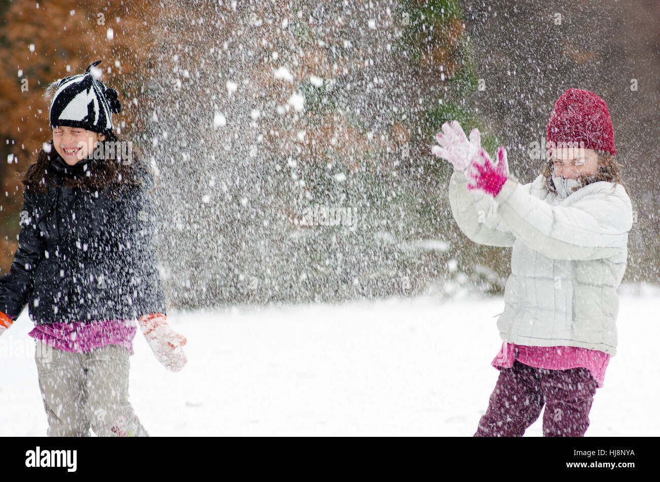 Two girls playing in the snow Stock Photo