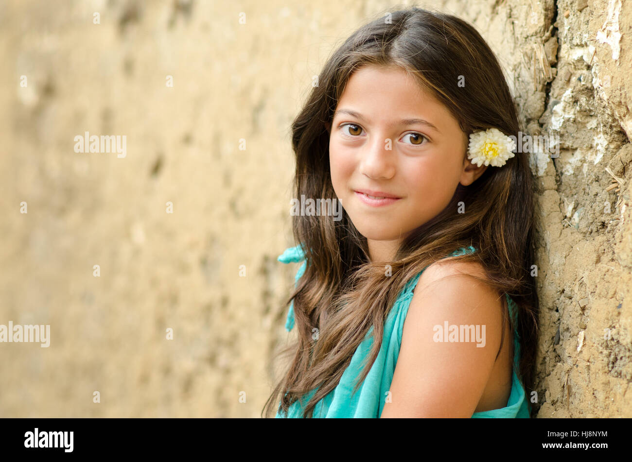 Portrait of a smiling girl with a flower in her hair Stock Photo