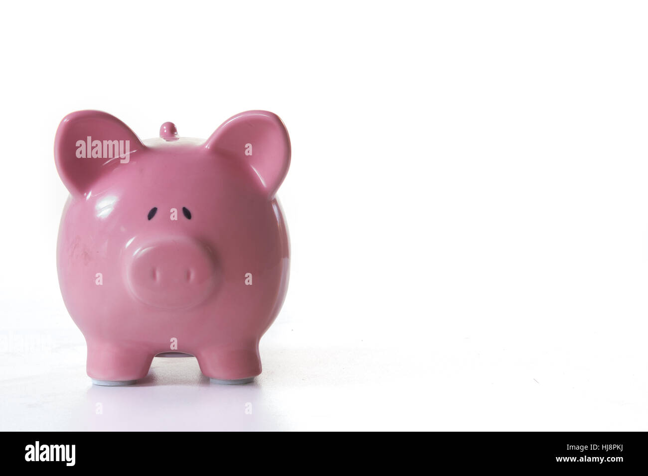 Pink ceramic piggy bank standing on white background Stock Photo - Alamy