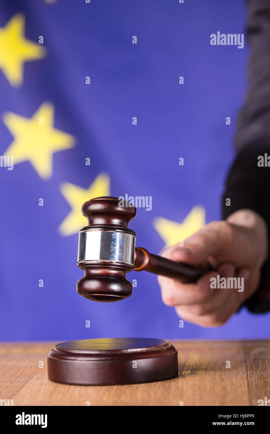 Hand babout to bang gavel on sounding block on european union flag background Stock Photo