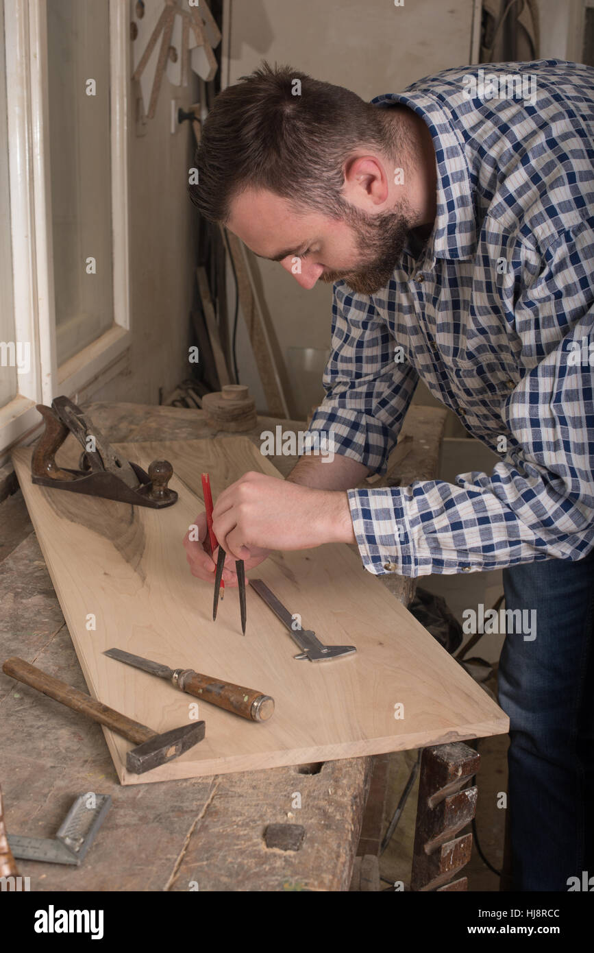 Carpenter using measuring tool Stock Photo