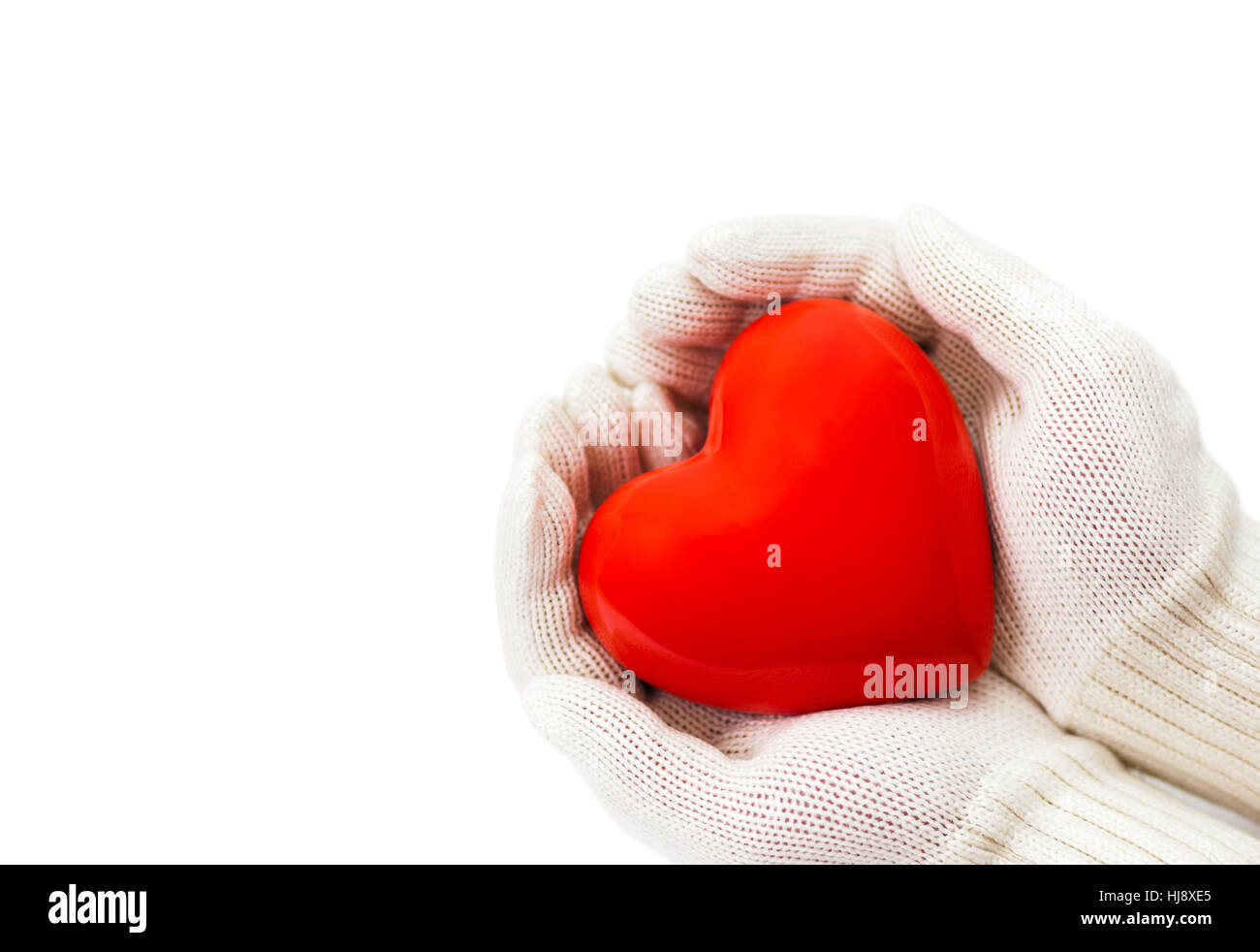 Red heart in white warm wool gloves isolated on white with clipping path Stock Photo