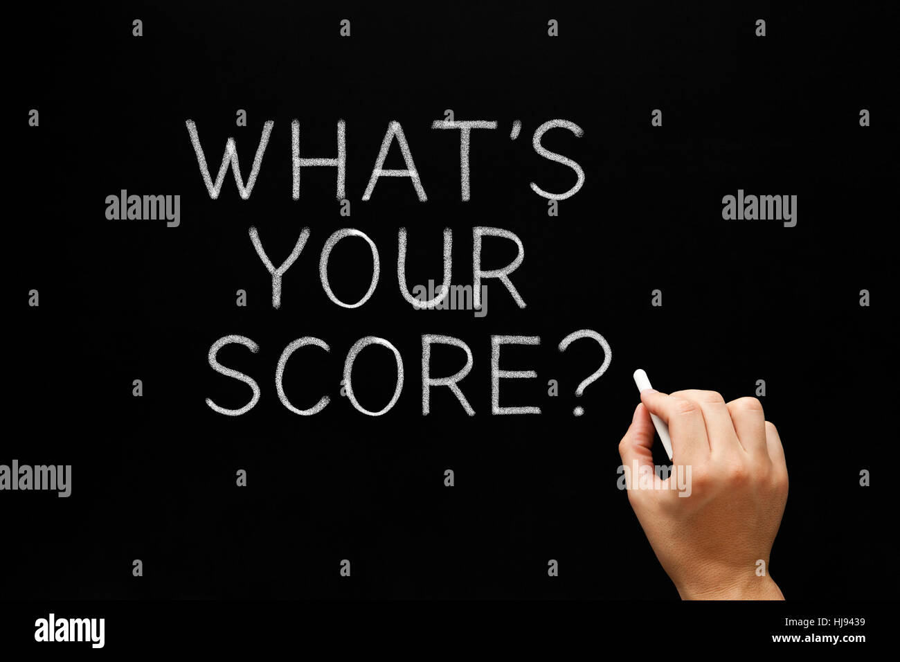 Hand writing What's Your Score with white chalk on blackboard. Stock Photo
