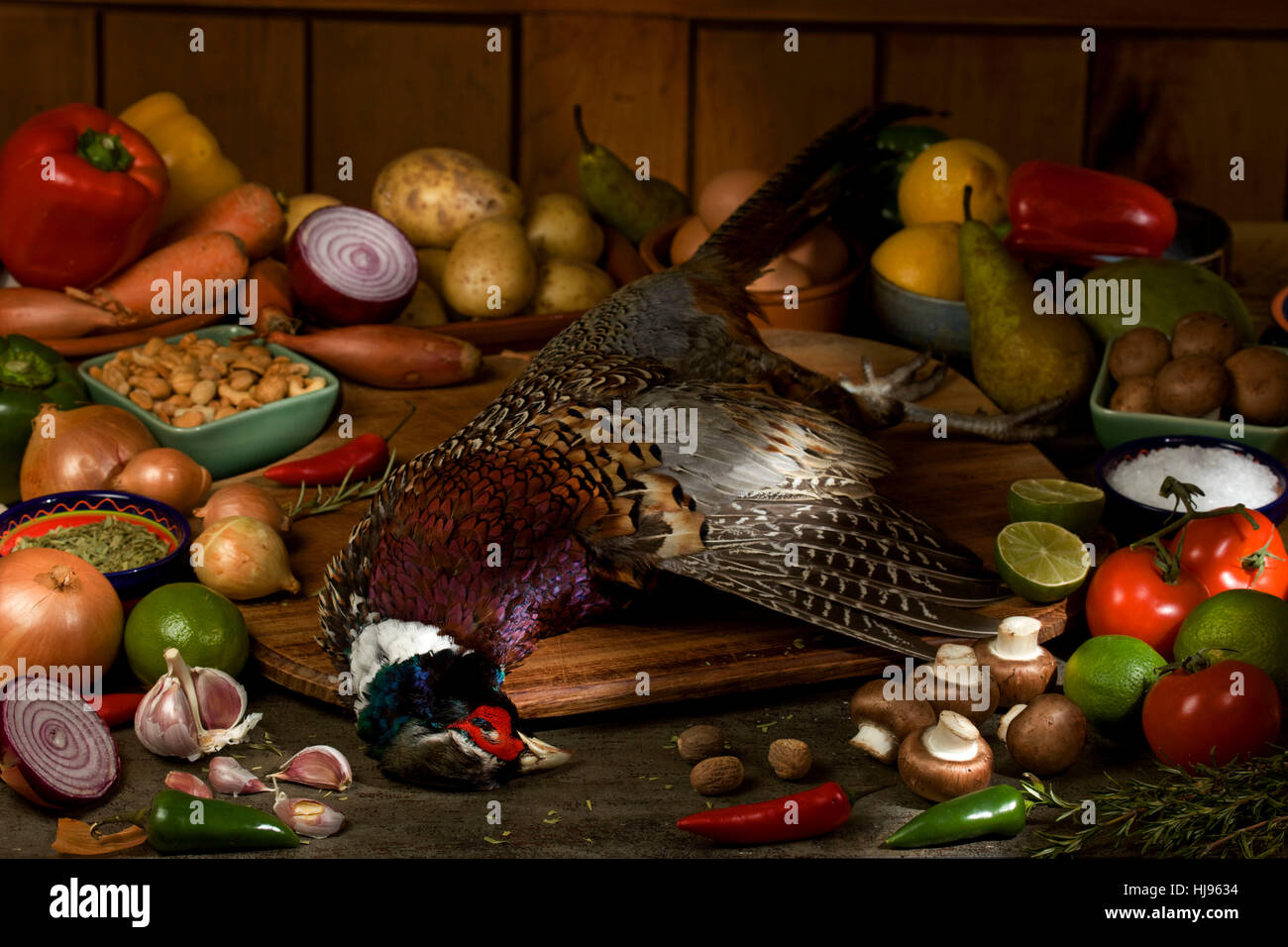 Pheasant with raw ingredients on table Stock Photo