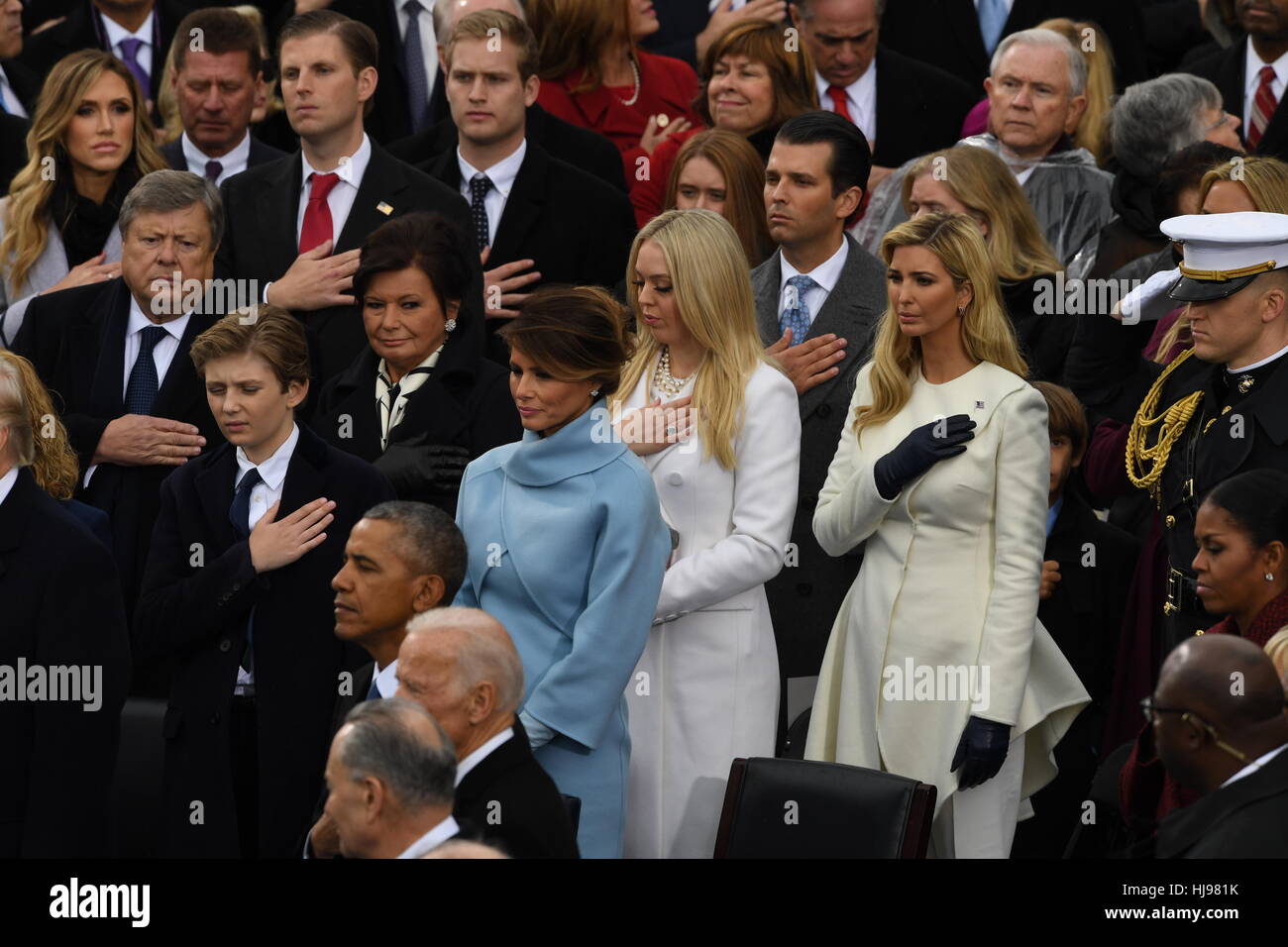 Melania Trump stands with the Trump family during the national anthem following the swearing in ceremony of her husband President Donald Trump during the President Inaugural Ceremony on Capitol Hill January 20, 2017 in Washington, DC. Donald Trump became the 45th President of the United States in the ceremony. Stock Photo
