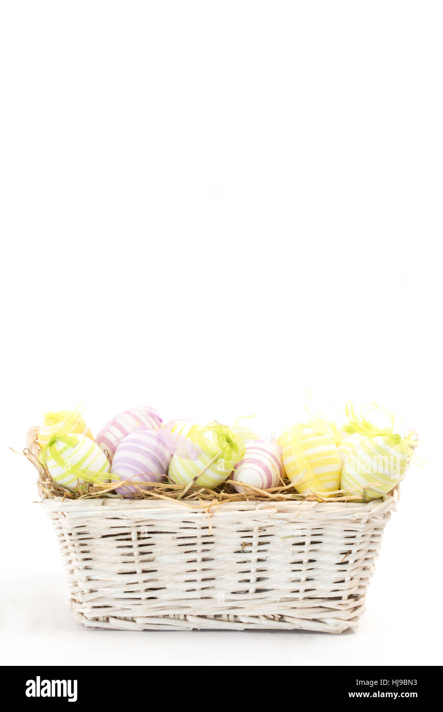 Easter eggs in basket against white background Stock Photo - Alamy