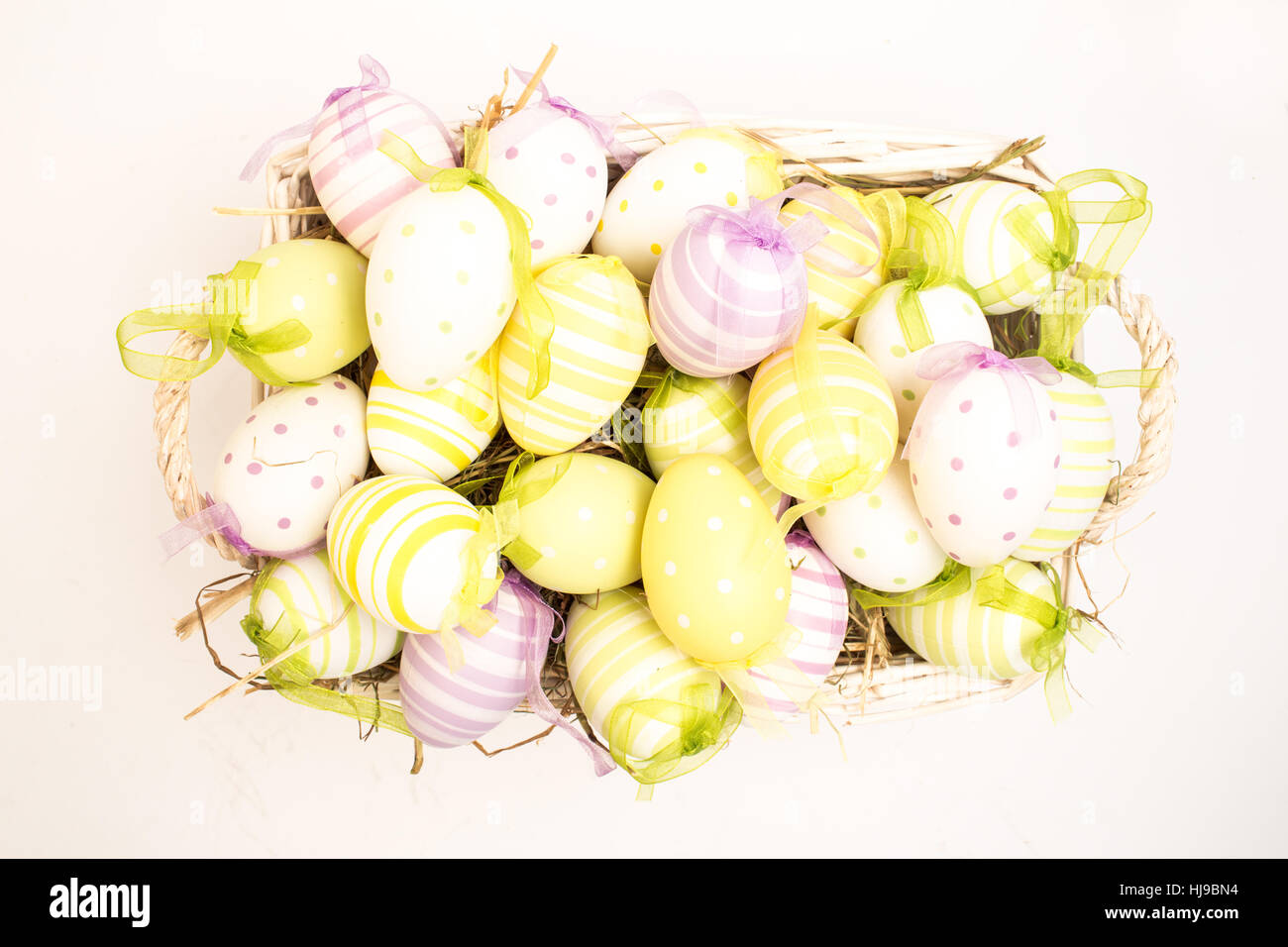 Colourful easter eggs in basket on white background Stock Photo - Alamy