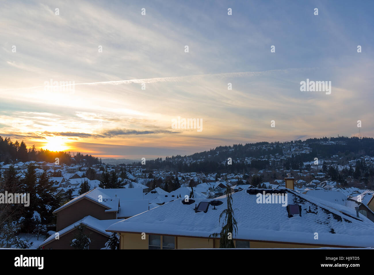 Happy Valley Oregon suburban neighborhood homes covered in snow during winter sunset Stock Photo