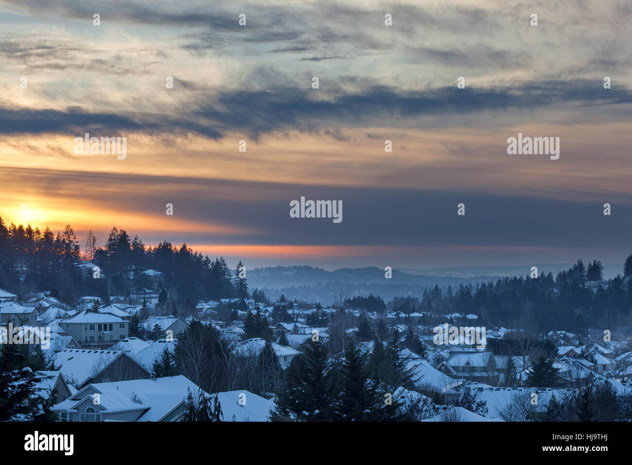 Happy Valley Oregon suburban neighborhood homes covered in snow during sunset Stock Photo