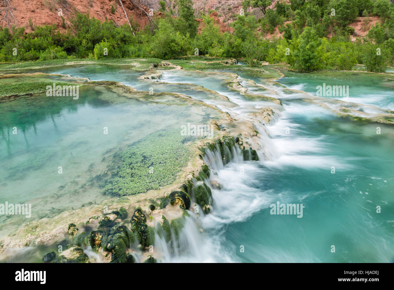 The Crystal Clear Turquoise Waters Of Havasu Creek Flow Over Stock