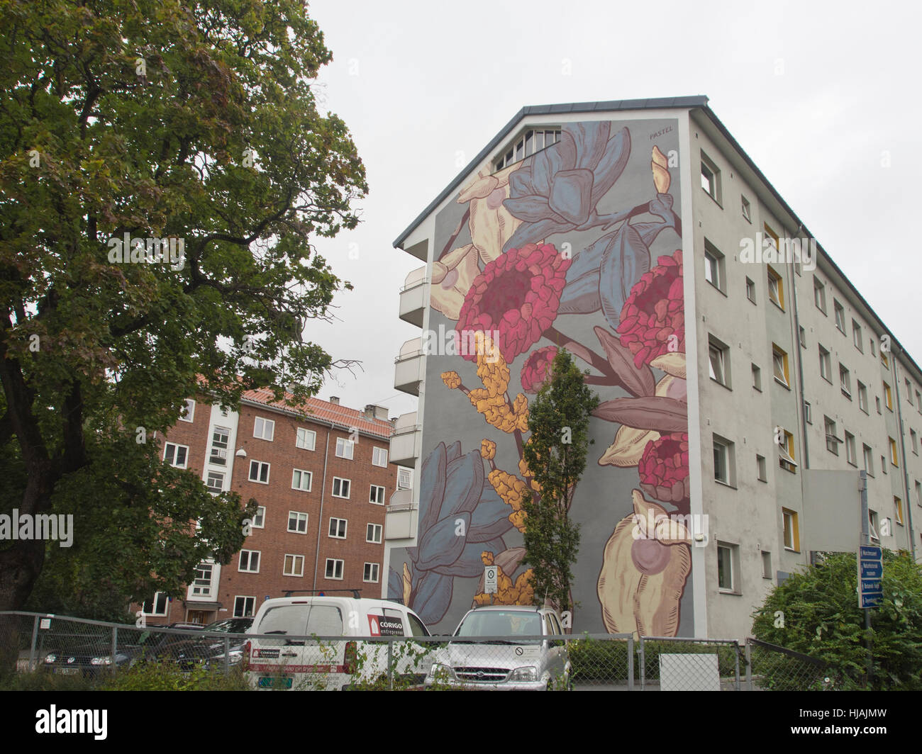 Side of an apartment block covered with a beautiful mural in subdued colours, Tøyen Oslo Norway - artist 'pastel' Stock Photo