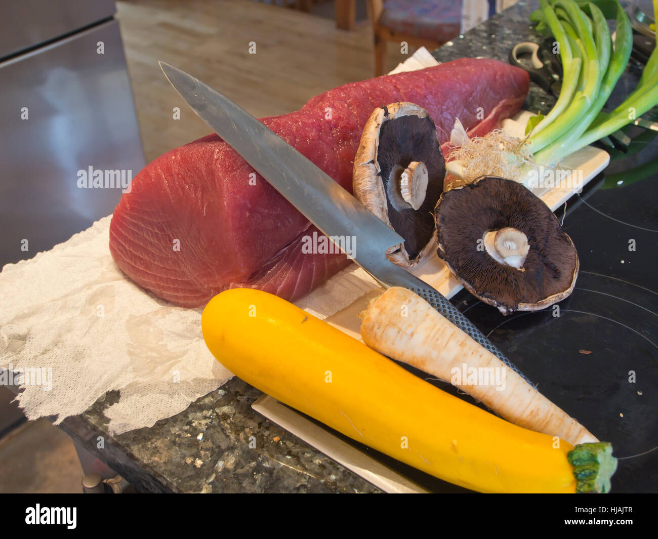 Tuna filet ready for cutting into steaks in a modern kitchen