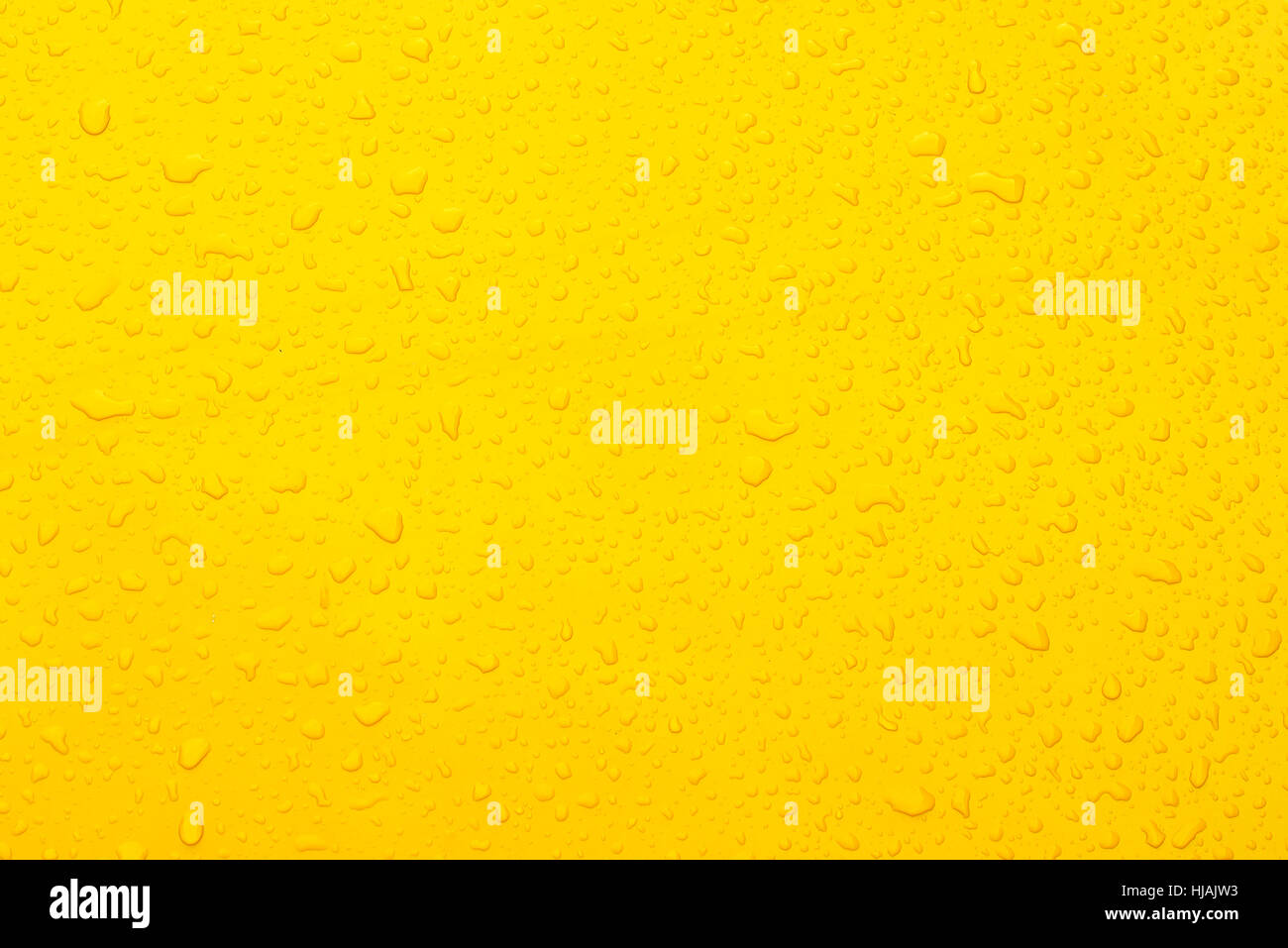 Water drop yellow collor background Stock Photo - Alamy