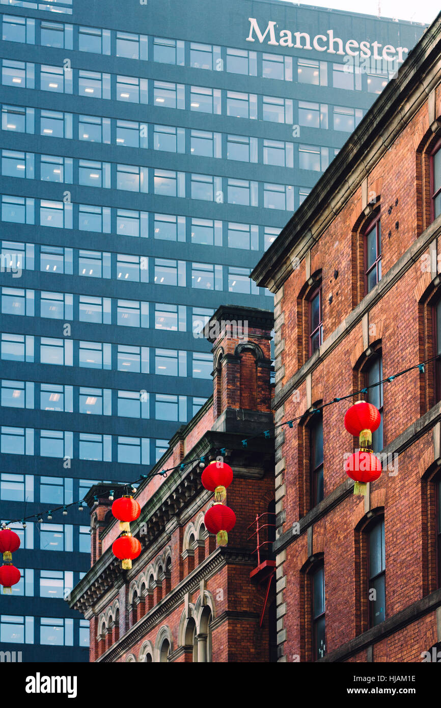 Manchester's Chinatown decorated with red lanterns and Manchester One in the background Stock Photo