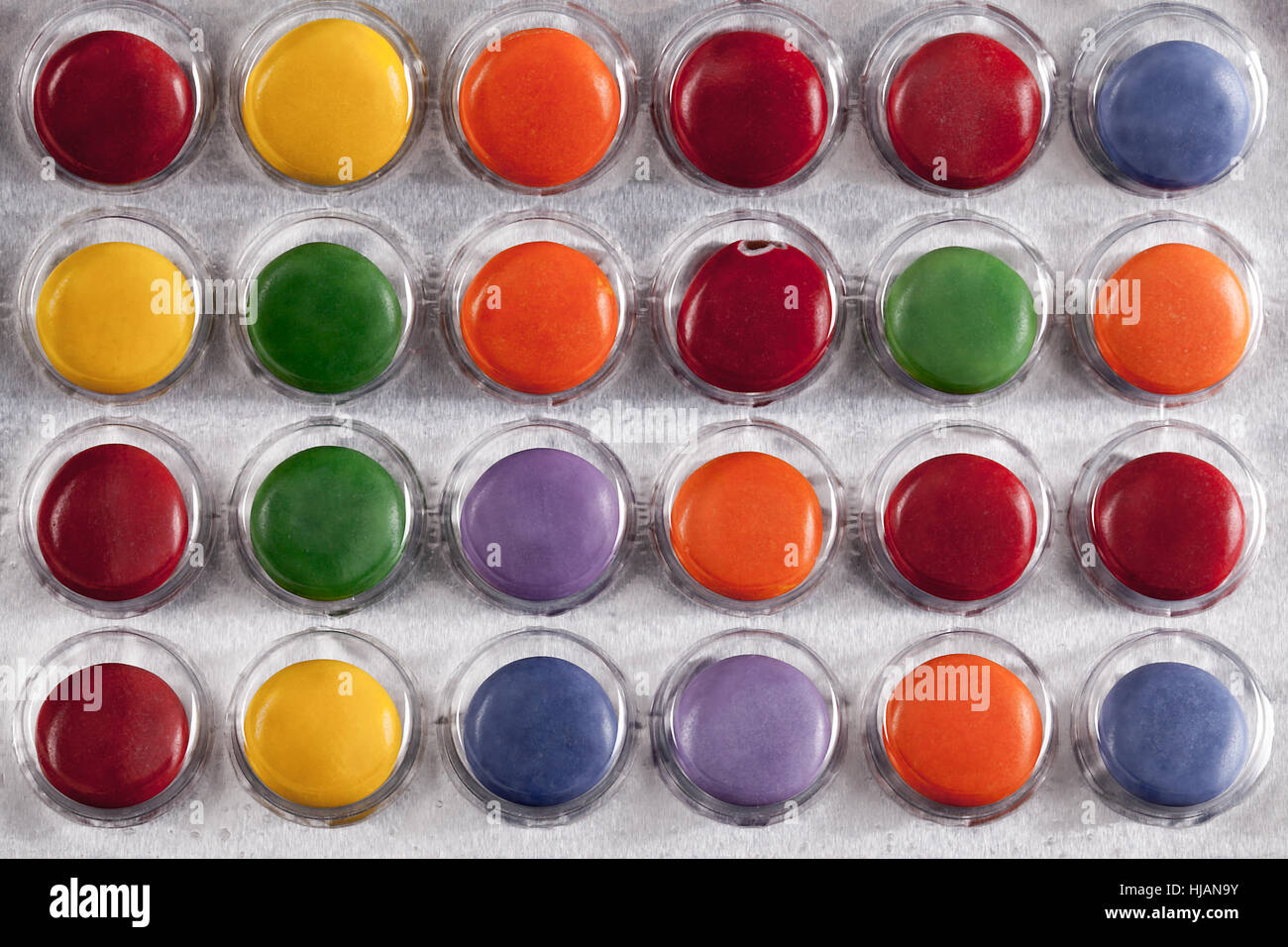 Pills in a bubble pack viewed from above. Bright colours and round