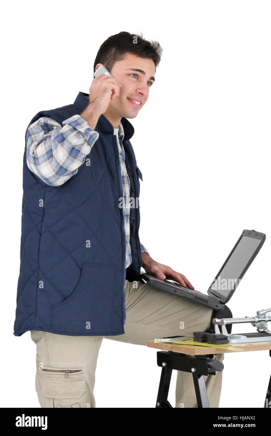 craftsman with laptop and mobile phone Stock Photo - Alamy