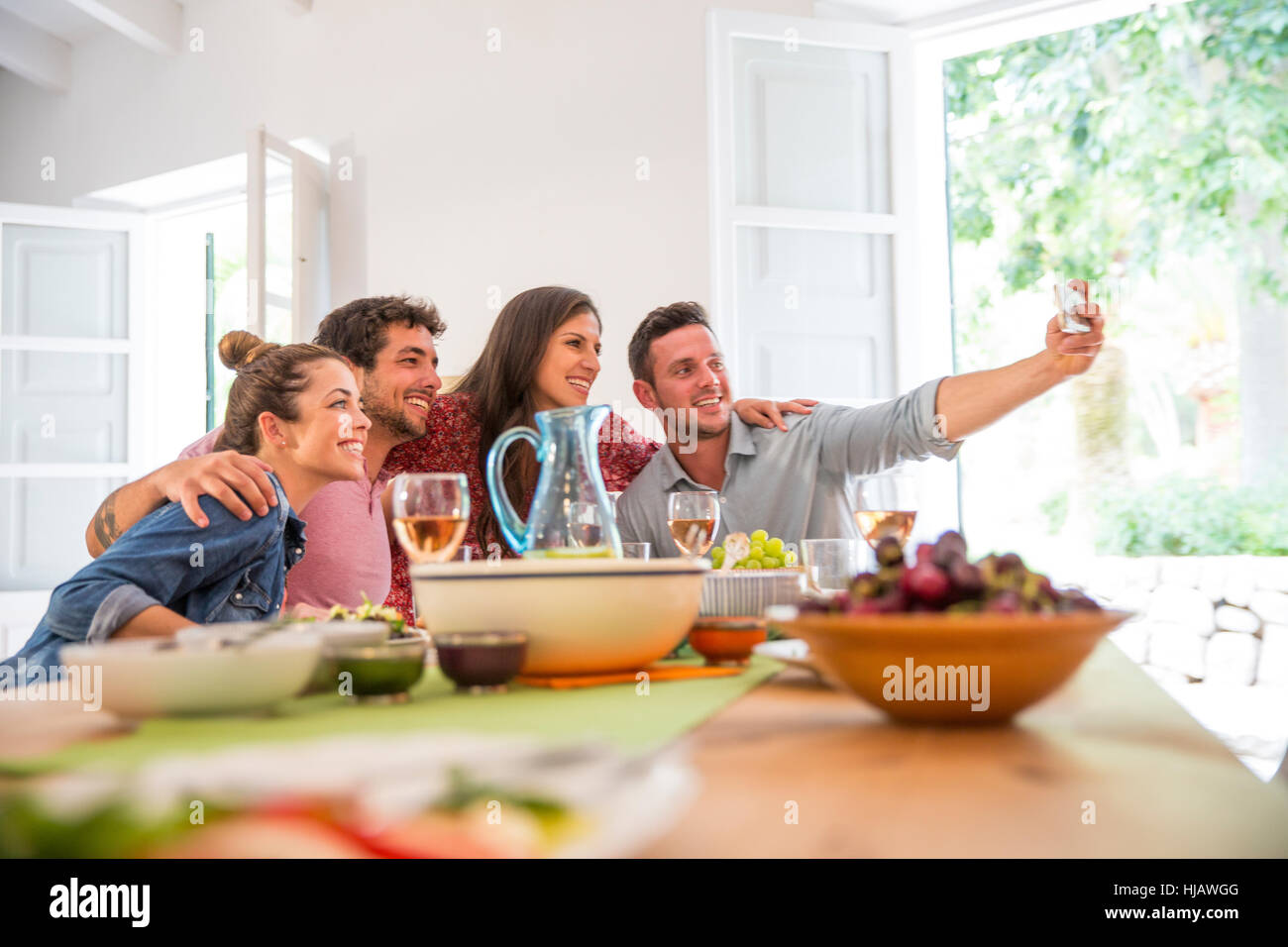 Friends dining together, taking a selfie Stock Photo - Alamy