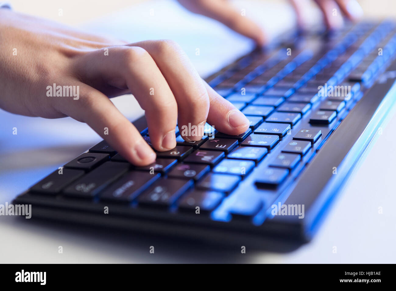 Keyboard Click Image Click! Hands of a man on a keyboard with blue backlighting Stock Photo ...