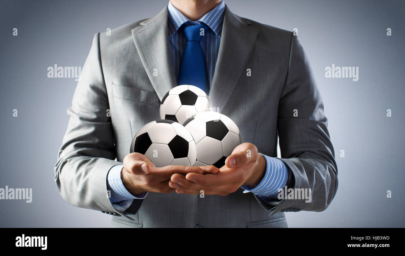 Close up of businessman holding soccer ball in hand Stock Photo - Alamy