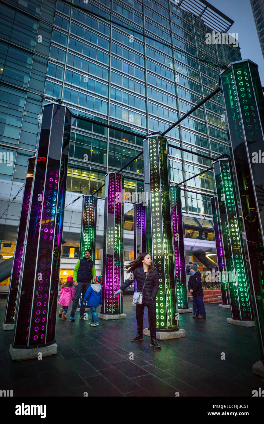 Visitors to a winter light exhibition in front of Cathedral of Mirrors installation Canary Wharf Stock Photo