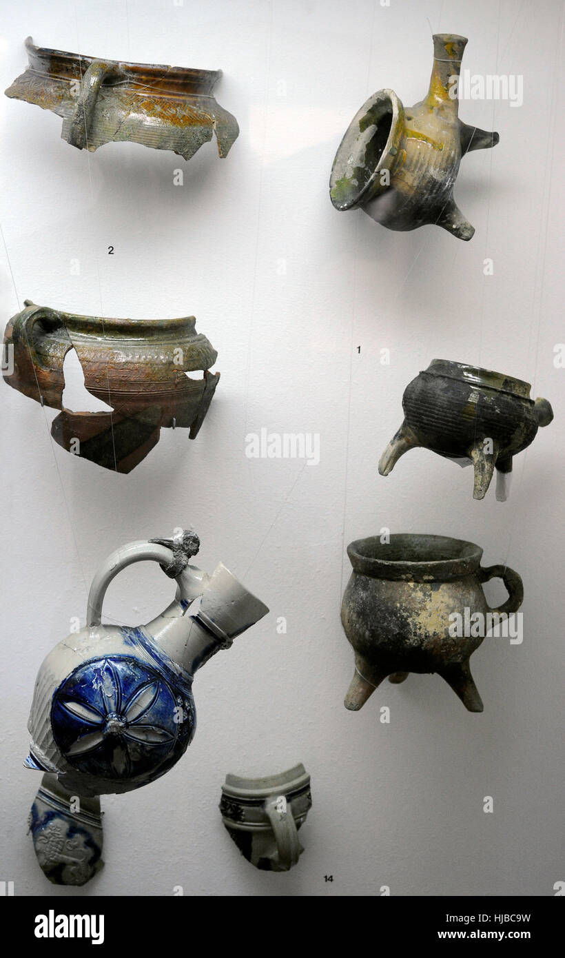Polish pottery. Fragments of kitchen utensils of three-legged pots and pans and flat bottom pots. 17th-18th century. Archaeological Museum of Gdansk. Poland. Europe Stock Photo