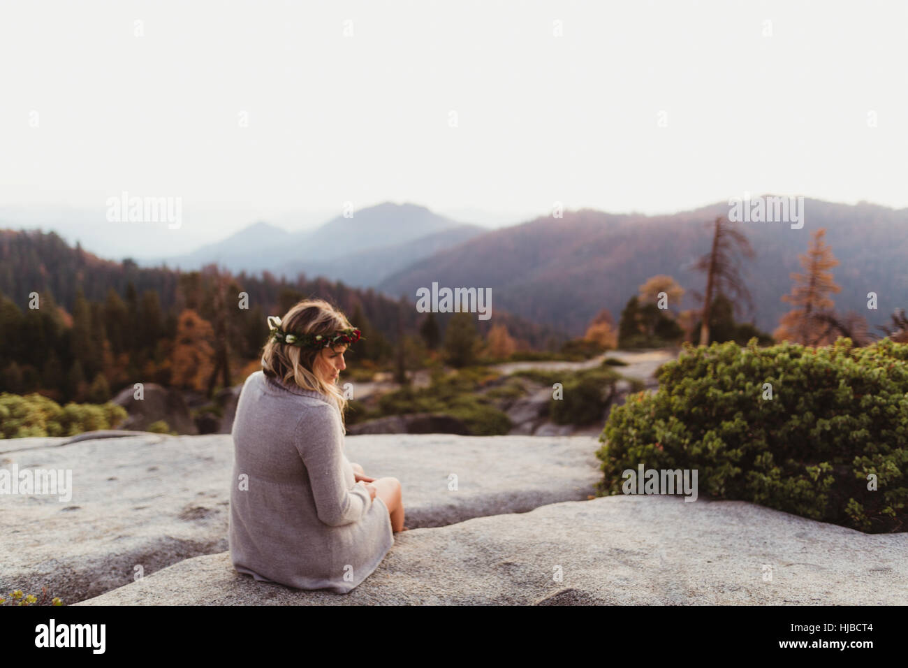 Rear view of woman sitting on rocks in mountains, Sequoia national park, California, USA Stock Photo