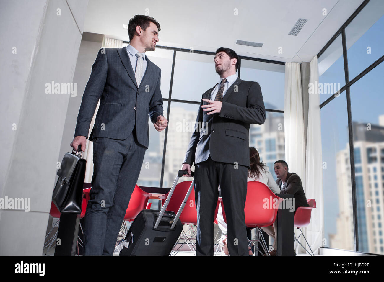 Two businessmen arriving in hotel lobby Stock Photo - Alamy