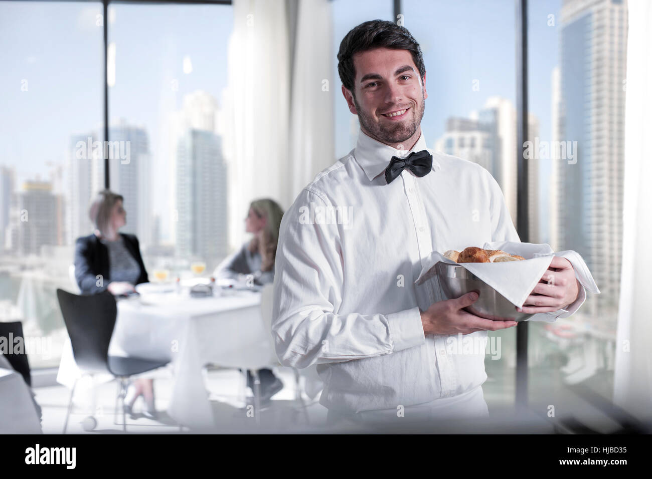 Portrait of young male waiter in hotel restaurant Stock Photo