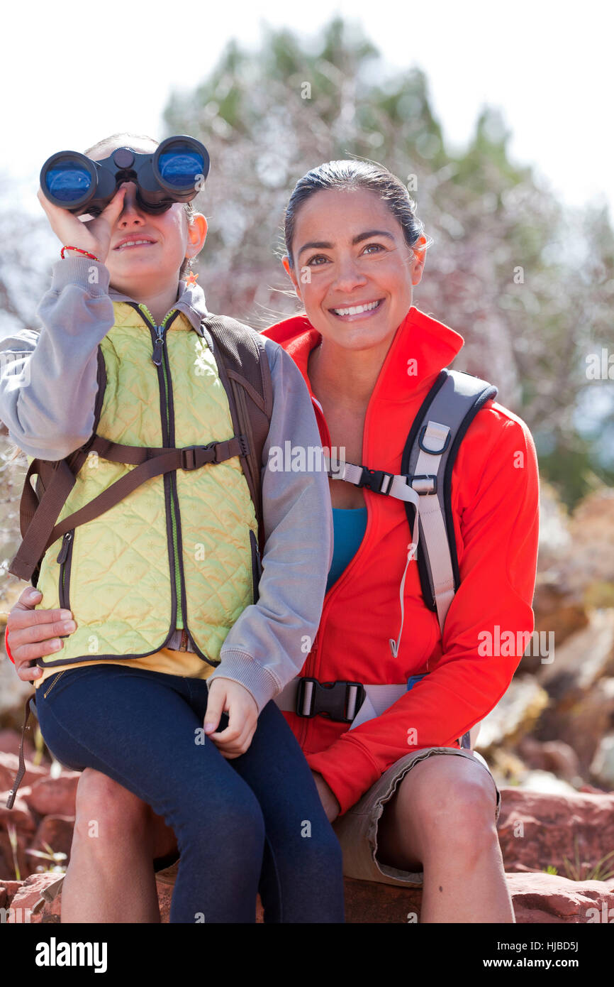 Portrait of mature woman and son looking through binoculars, Sedona, Arizona, USA Stock Photo