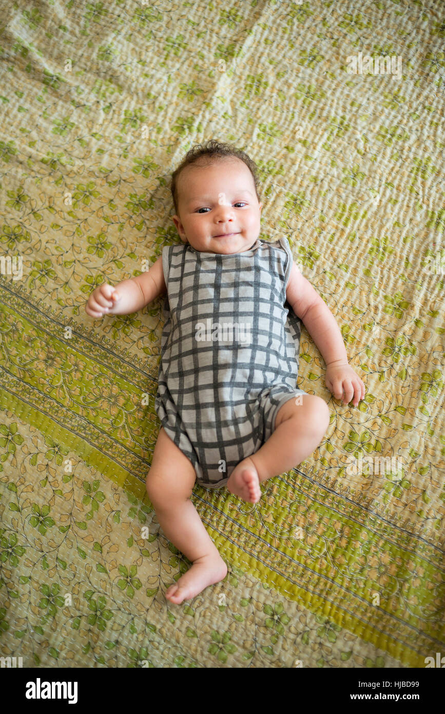 Baby lying on bed Stock Photo Alamy