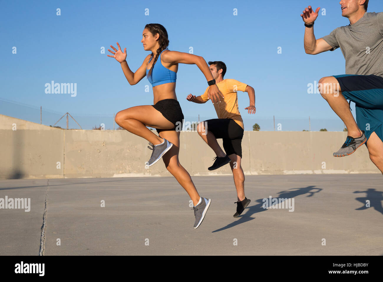 Athletes doing high knees exercise, Van Nuys, California, USA Stock Photo