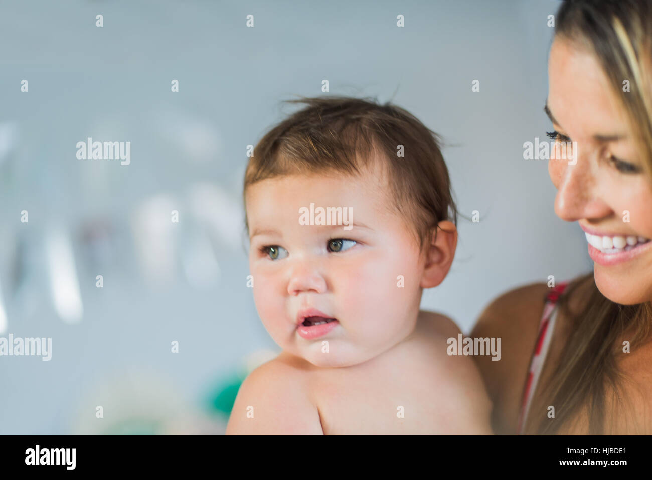 Mother playing with toddler in arms Stock Photo